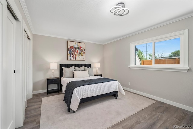 4903 W 11th Ave, Denver, CO 80204 - bedroom featuring wood finished floors, a closet, and crown molding