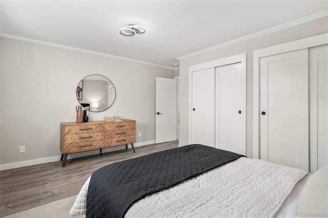 4903 W 11th Ave, Denver, CO 80204 - bedroom with wood finished floors, ornamental molding, and two closets