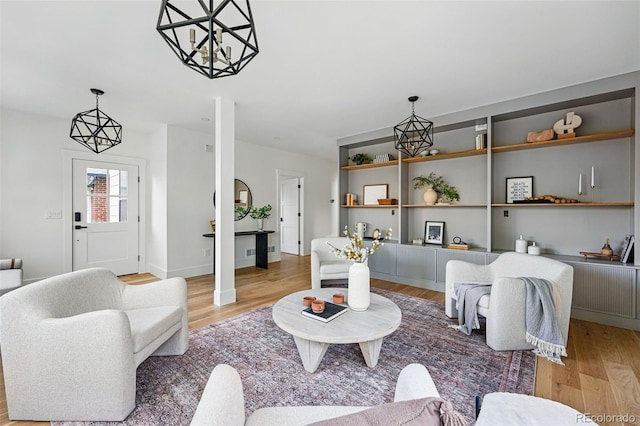 2391 Hudson St, Denver, CO 80207 - living area featuring wood finished floors and a chandelier