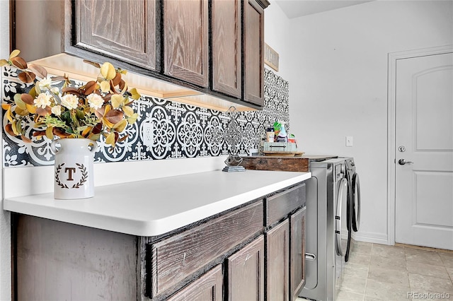 washroom with washing machine and clothes dryer and cabinet space