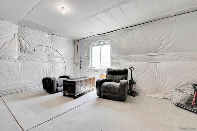 sitting room featuring concrete flooring