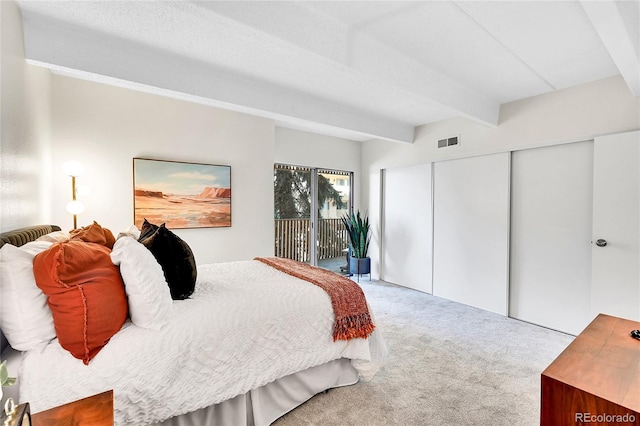 carpeted bedroom with visible vents, beamed ceiling, a closet, and access to outside