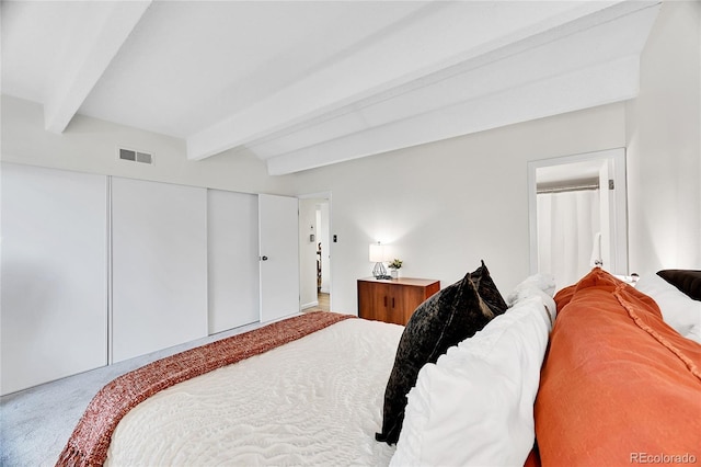 carpeted bedroom featuring beam ceiling, visible vents, and a closet