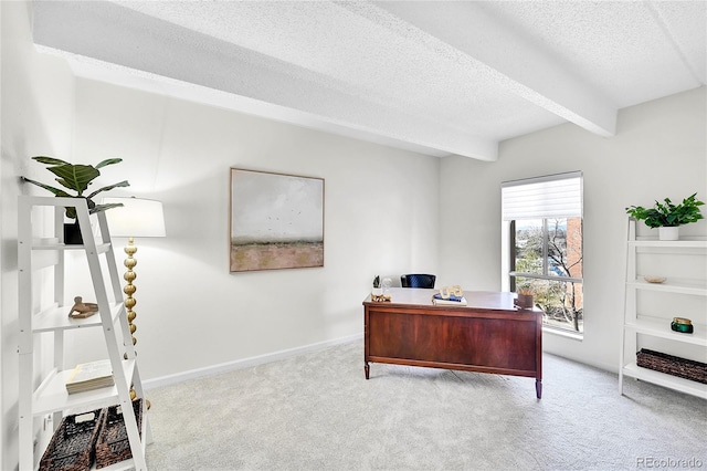 office space with beamed ceiling, carpet, baseboards, and a textured ceiling