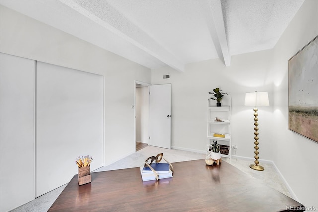 office space featuring visible vents, beam ceiling, a textured ceiling, and baseboards