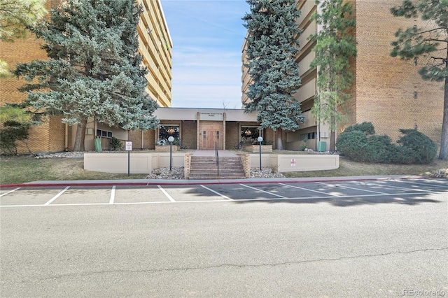 view of building exterior featuring uncovered parking