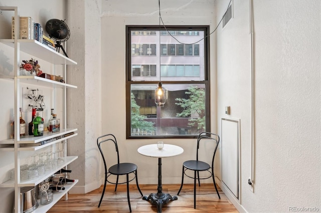 dining space with hardwood / wood-style flooring