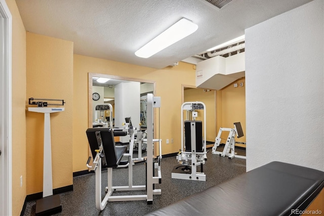 exercise room with a textured ceiling