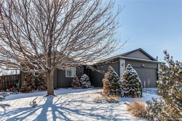 view of front of home with an attached garage and brick siding