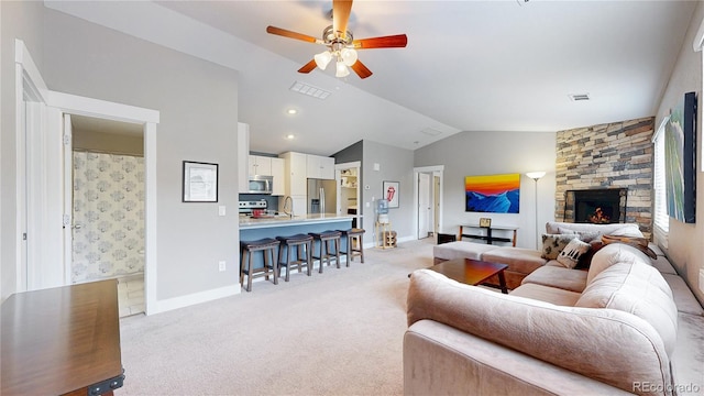 18274 W 58th Pl Unit 37, Golden, CO 80403 - living room featuring vaulted ceiling, light carpet, a ceiling fan, and a fireplace