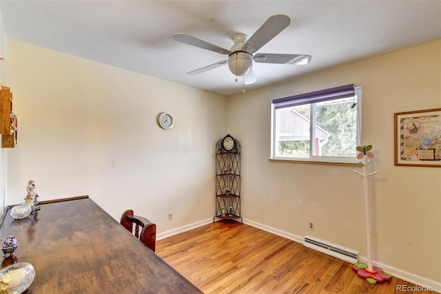 office space featuring light hardwood / wood-style floors, ceiling fan, and baseboard heating