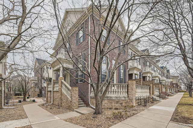 view of front of house featuring a residential view and brick siding