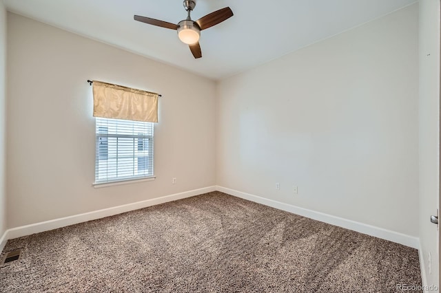 carpeted empty room with ceiling fan, visible vents, and baseboards