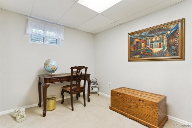 office featuring baseboards, light colored carpet, and a drop ceiling