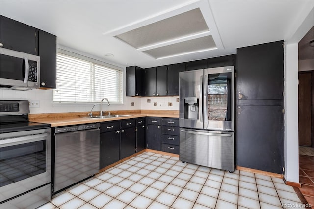 kitchen featuring decorative backsplash, appliances with stainless steel finishes, and sink