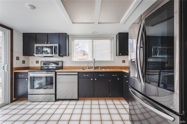 kitchen with decorative backsplash, sink, and stainless steel appliances