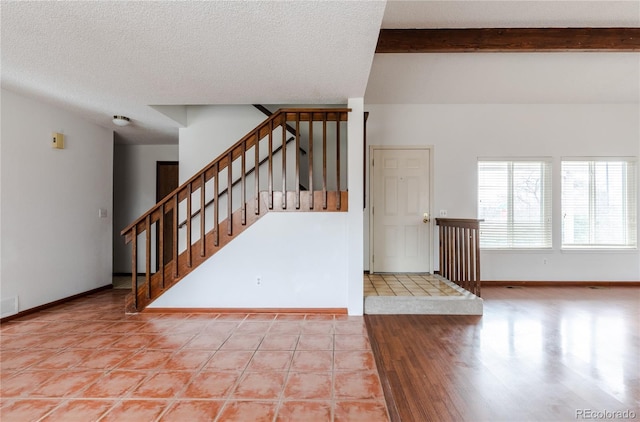 staircase featuring a textured ceiling and tile patterned floors