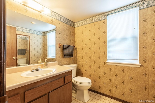 bathroom featuring tile patterned floors, toilet, and vanity