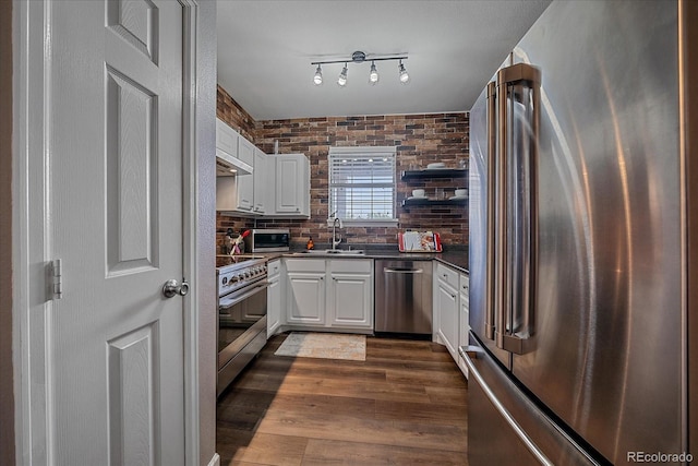 7413 S Quail Cir Unit 1435, Littleton, CO 80127 - kitchen with stainless steel appliances, dark countertops, white cabinets, and a sink