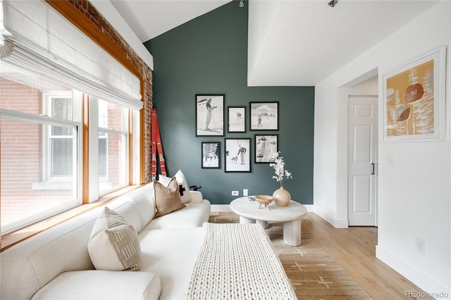 3249 W Fairview Pl Unit 207, Denver, CO 80211 - living area with light wood-style flooring, vaulted ceiling, and baseboards