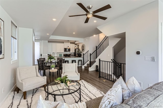 living room with hardwood / wood-style floors and ceiling fan