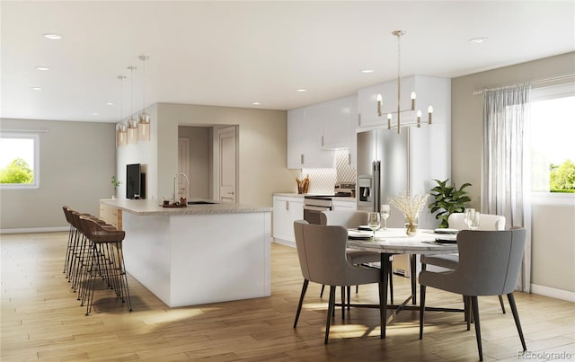 kitchen featuring stainless steel electric range, a sink, light wood-style flooring, white cabinets, and recessed lighting