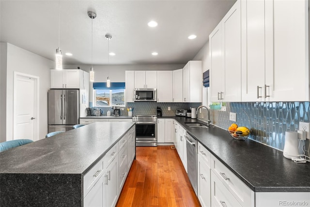1353 Quaker St, Golden, CO 80401 - kitchen featuring stainless steel appliances, dark countertops, recessed lighting, and a kitchen island