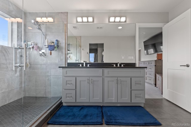 1353 Quaker St, Golden, CO 80401 - full bath with plenty of natural light, double vanity, a tile shower, and tile patterned flooring