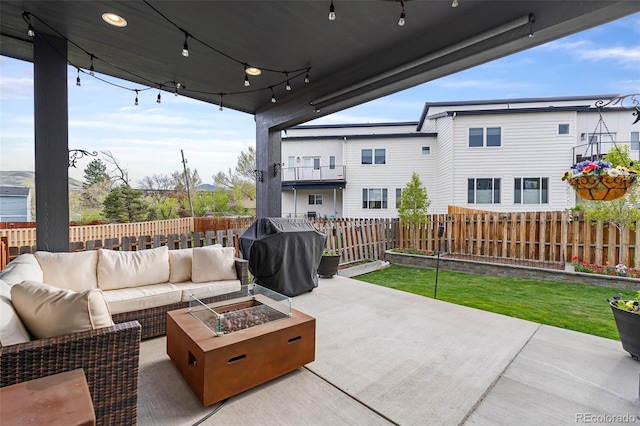 1353 Quaker St, Golden, CO 80401 - fenced backyard featuring area for grilling, an outdoor living space with a fire pit, and a patio area