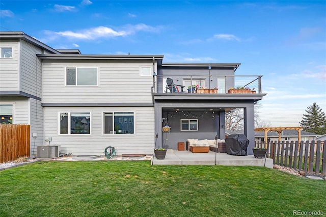 1353 Quaker St, Golden, CO 80401 - back of property with a balcony, outdoor lounge area, a fenced backyard, and a patio area