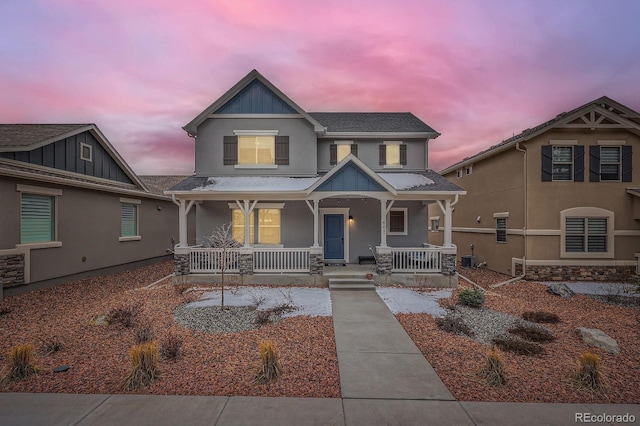 668 Sage Forest Ln, Monument, CO 80132 - craftsman-style home featuring stucco siding, covered porch, board and batten siding, and roof with shingles