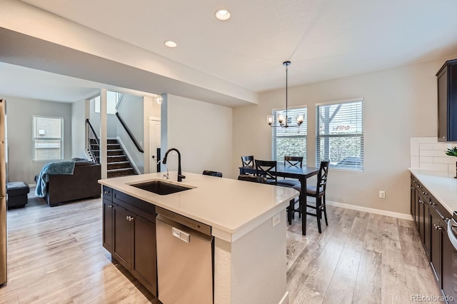 668 Sage Forest Ln, Monument, CO 80132 - kitchen featuring dishwasher, a sink, light wood finished floors, a chandelier, and light countertops