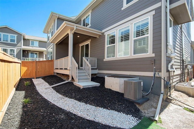 view of exterior entry with central AC unit