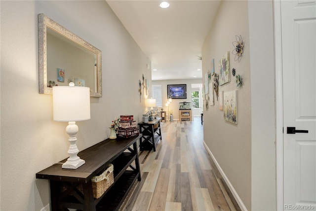 hallway featuring wood finished floors and recessed lighting