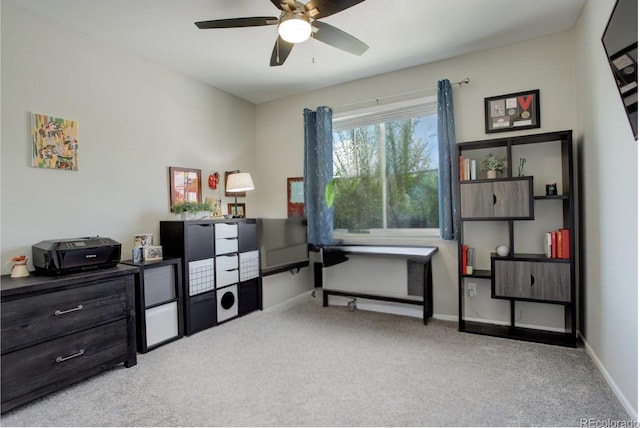 carpeted home office featuring ceiling fan and baseboards