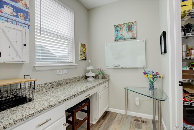 bathroom with wood finished floors and baseboards