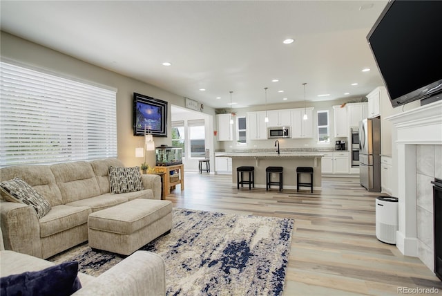 living room featuring light wood finished floors and recessed lighting