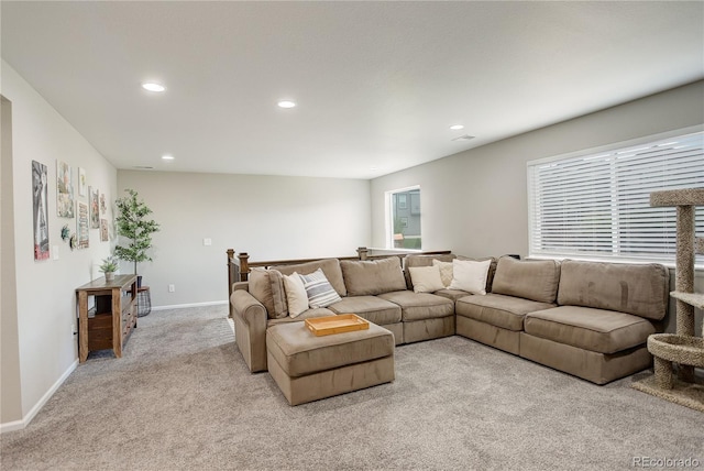 living area with light carpet, recessed lighting, healthy amount of natural light, and baseboards