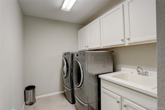 clothes washing area featuring washing machine and dryer, cabinet space, baseboards, and light tile patterned floors