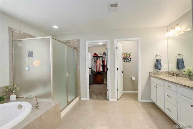 full bathroom with vanity, a stall shower, a spacious closet, tile patterned flooring, and recessed lighting