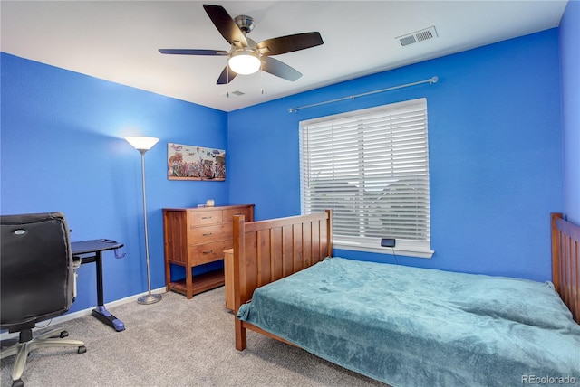 bedroom with carpet, baseboards, ceiling fan, and an office area