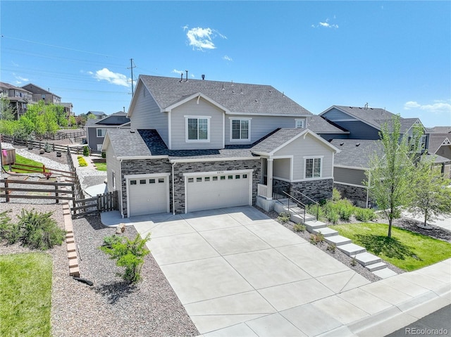 6630 S Coolidge Ct, Aurora, CO 80016 - view of front of property featuring driveway, an attached garage, a shingled roof, and stone siding