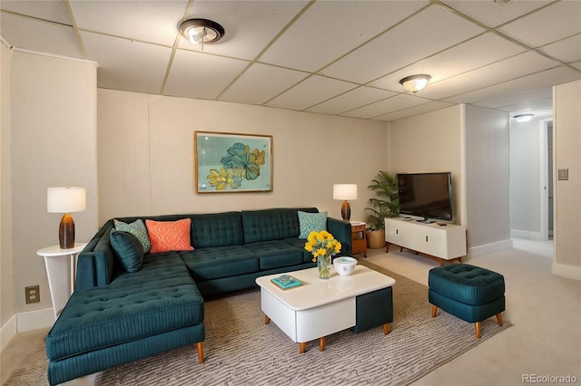 carpeted living room with a drop ceiling