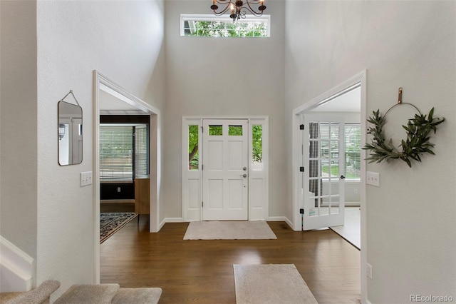 7027 Chestnut Hill St, Highlands Ranch, CO 80130 - foyer entrance with a chandelier, wood finished floors, healthy amount of natural light, and a high ceiling