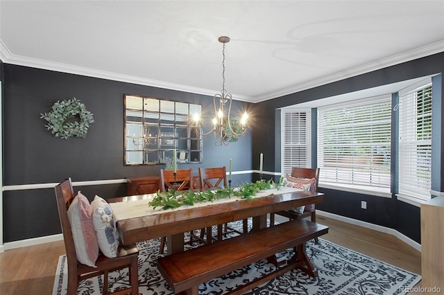 7027 Chestnut Hill St, Highlands Ranch, CO 80130 - dining space with healthy amount of natural light, wood finished floors, a chandelier, and ornamental molding