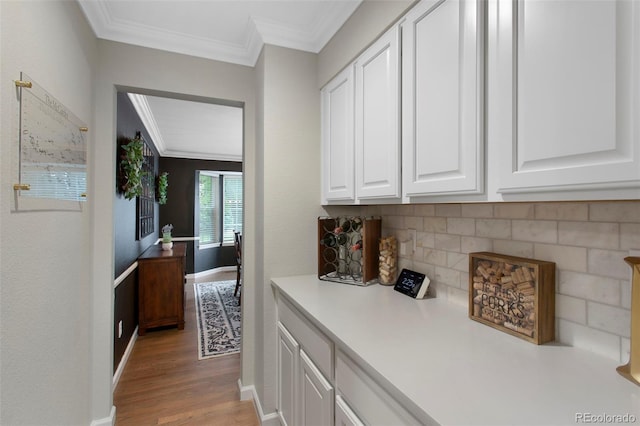 7027 Chestnut Hill St, Highlands Ranch, CO 80130 - hallway featuring ornamental molding and light wood-style flooring