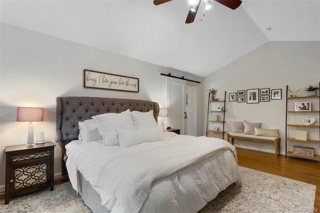 7027 Chestnut Hill St, Highlands Ranch, CO 80130 - bedroom featuring lofted ceiling, wood finished floors, a barn door, and ceiling fan