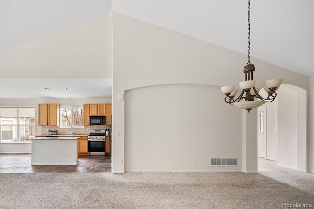 unfurnished living room with an inviting chandelier, high vaulted ceiling, sink, and carpet floors