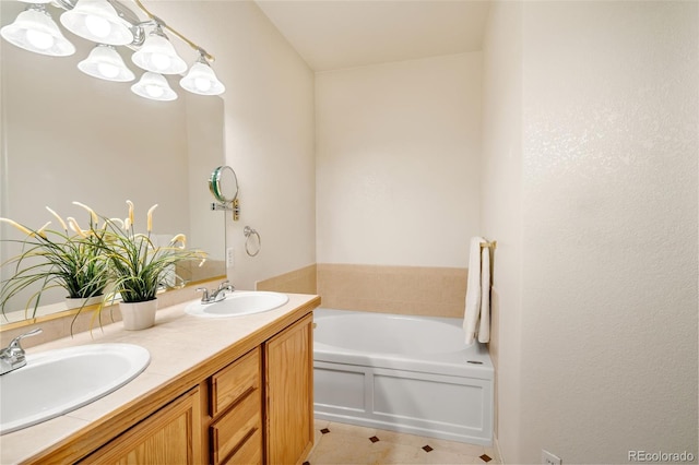 bathroom featuring a washtub, vanity, and tile patterned floors