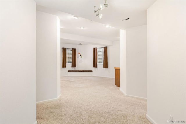 hallway featuring light carpet